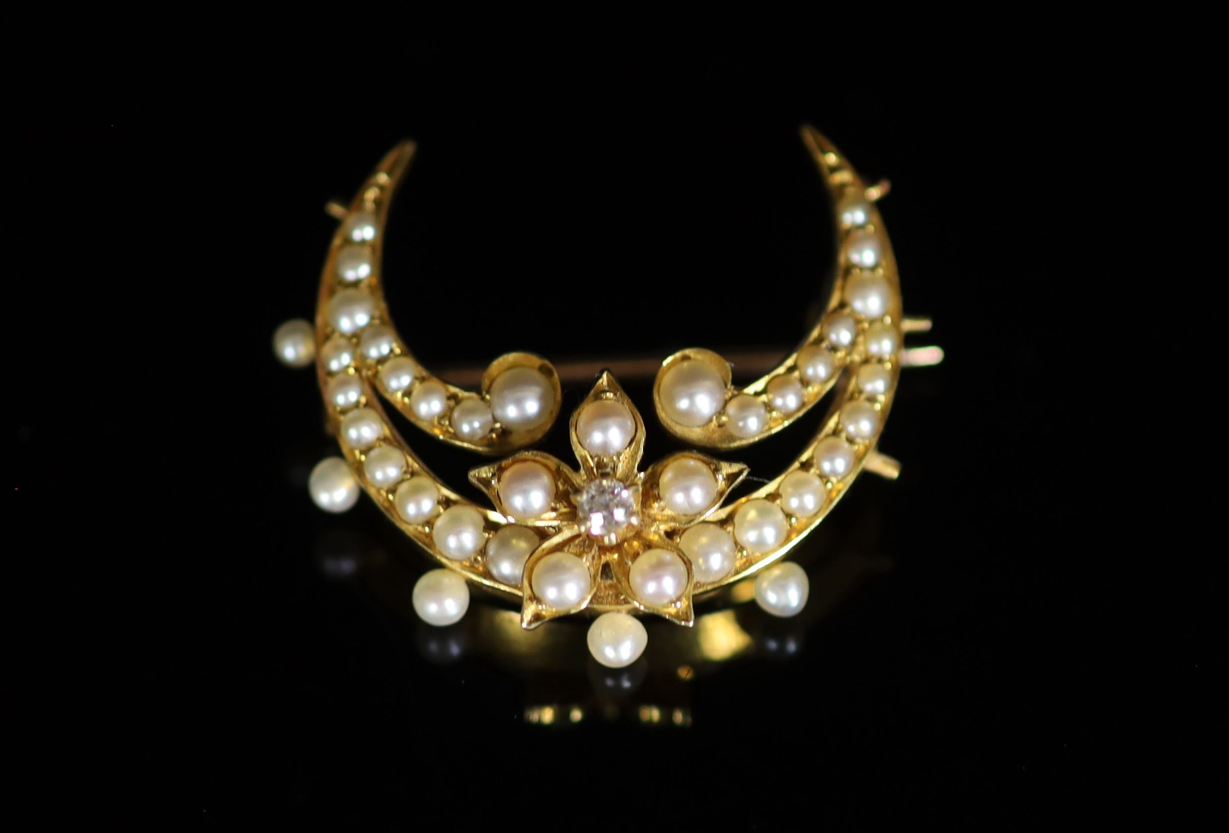 A Victorian gold, pearl and diamond set necklace, lacking drop, together with a similar crescent brooch